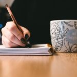 person-holding-white-ceramci-be-happy-painted-mug-851213 (1)