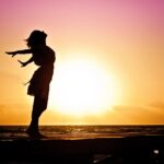 beach-woman-sunrise-silhouette-40192