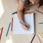 person-drawing-on-a-notebook-3855552