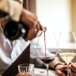 crop-man-pouring-red-wine-in-glass-in-restaurant-3756623