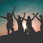 silhouette-of-four-people-against-sun-background-862848